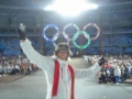 Mlli in front of the olympic symbol